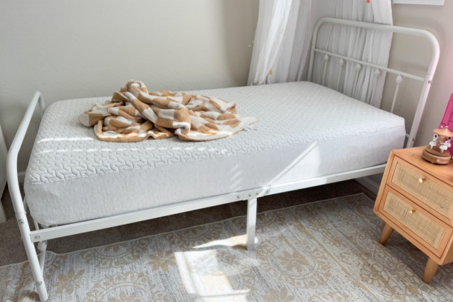 twin size mattress on white bed frame