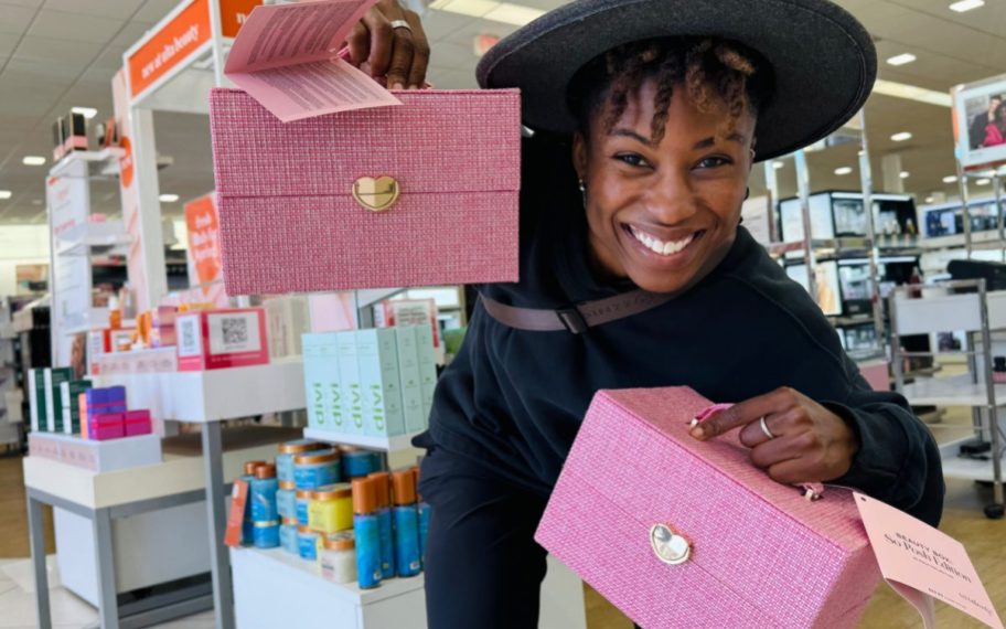 woman holding two ULTA beauty boxes in hand at the store