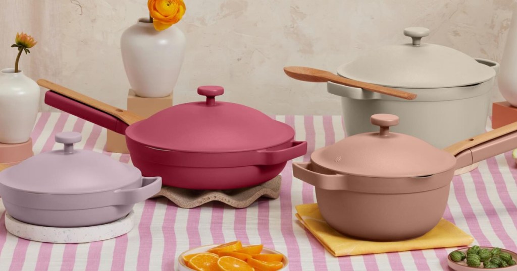 Pastel colored our place pans on table with pink and white striped tablecloth