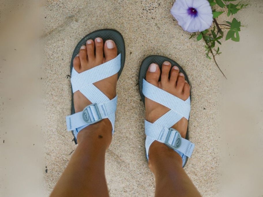 woman wearing chacos sandals on the beach