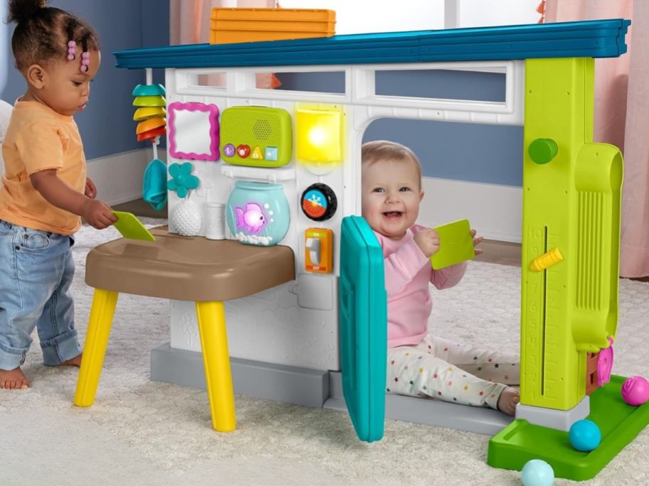 kids playing with Fisher-Price Laugh & Learn Ultimate Playhouse