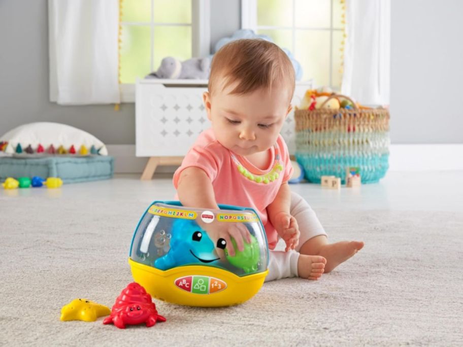 baby playing with Fisher-Price Laugh & Learn Magical Lights Fishbowl 