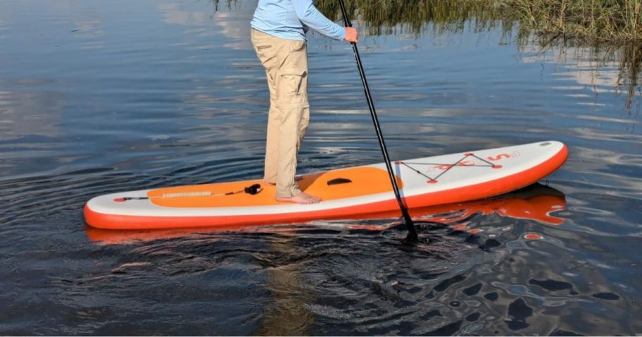 person on Inflatable Paddle Board in Sunset Orange in water