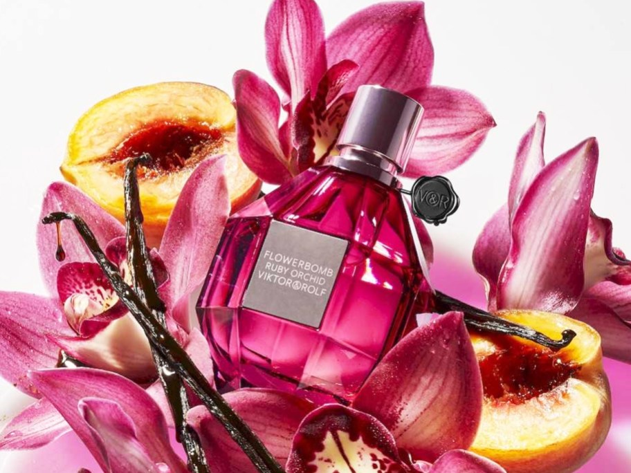 pink bottle of Viktor & Rolf Flowerbomb Ruby Orchid surrounded by pink flowers