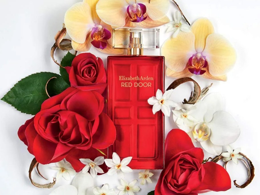 bottle of Elizabeth Arden Red Door surrounded by flowers