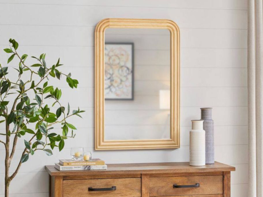 Home Decorators Collection Medium Arched Natural Wood Framed Mirror on wall above dresser