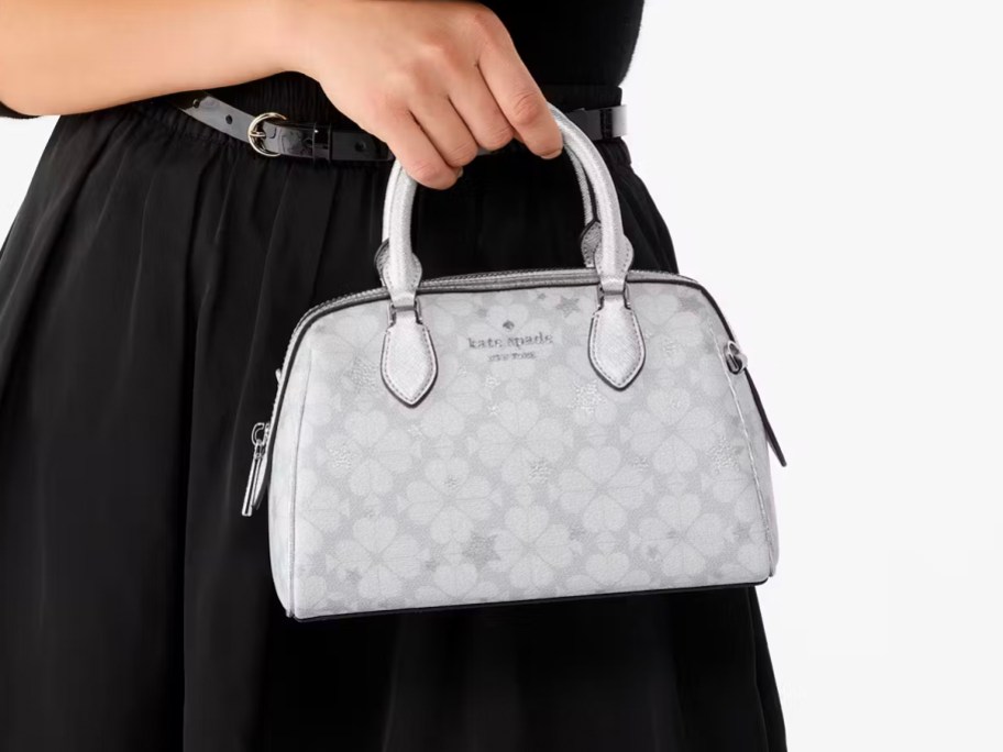 woman holding gray kate spade bag 