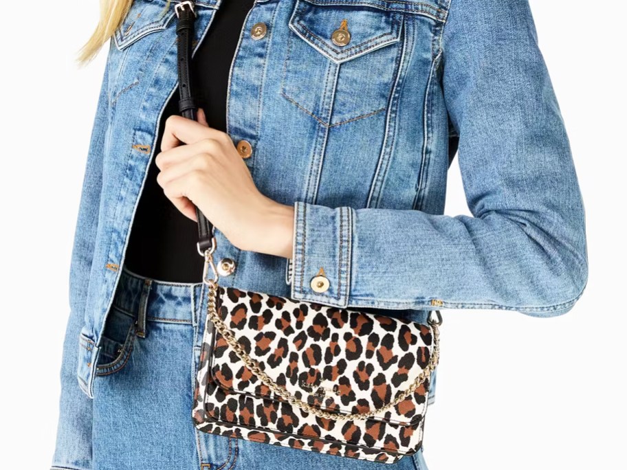 woman in a denim outfit with a leopard print crossbody bag