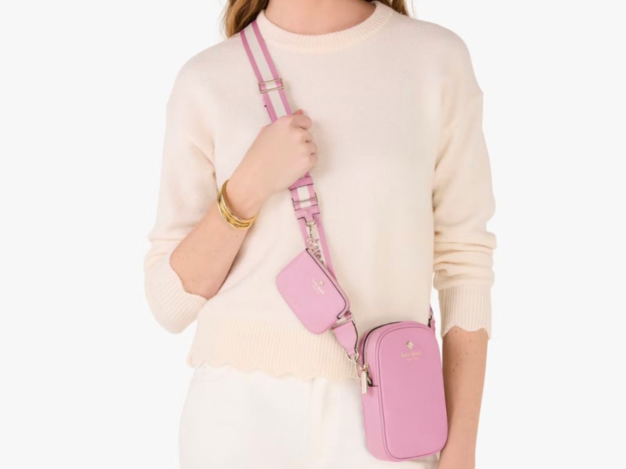 woman in beige sweater wearing pink crossbody kate spade bag