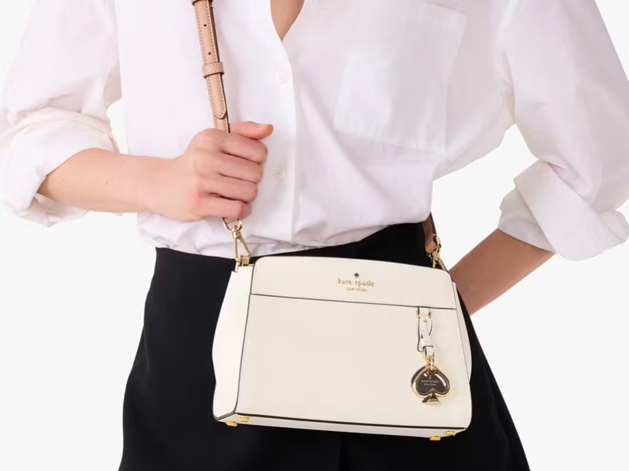 woman wearing white kate spade bag