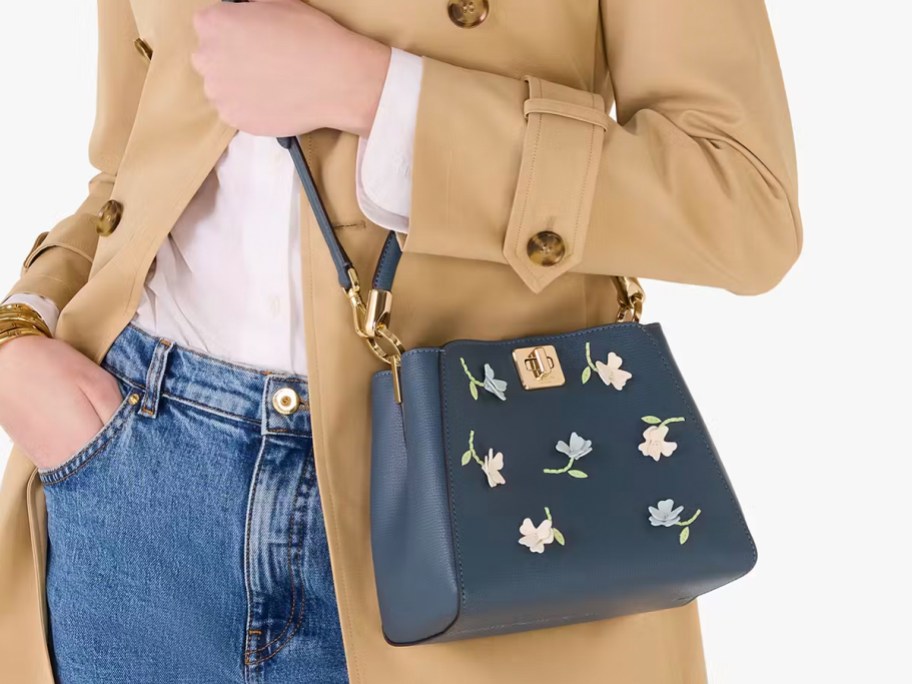 woman wearing blue flower kate spade bag