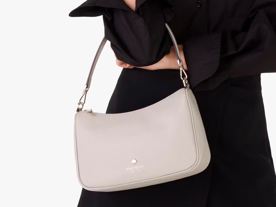 woman wearing gray kate spade bag 