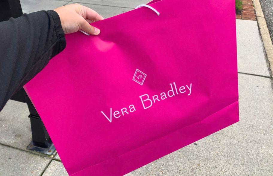 woman holding a vera bradley shopping bag