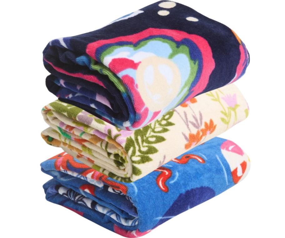 a stack of colorful beach towels stock images