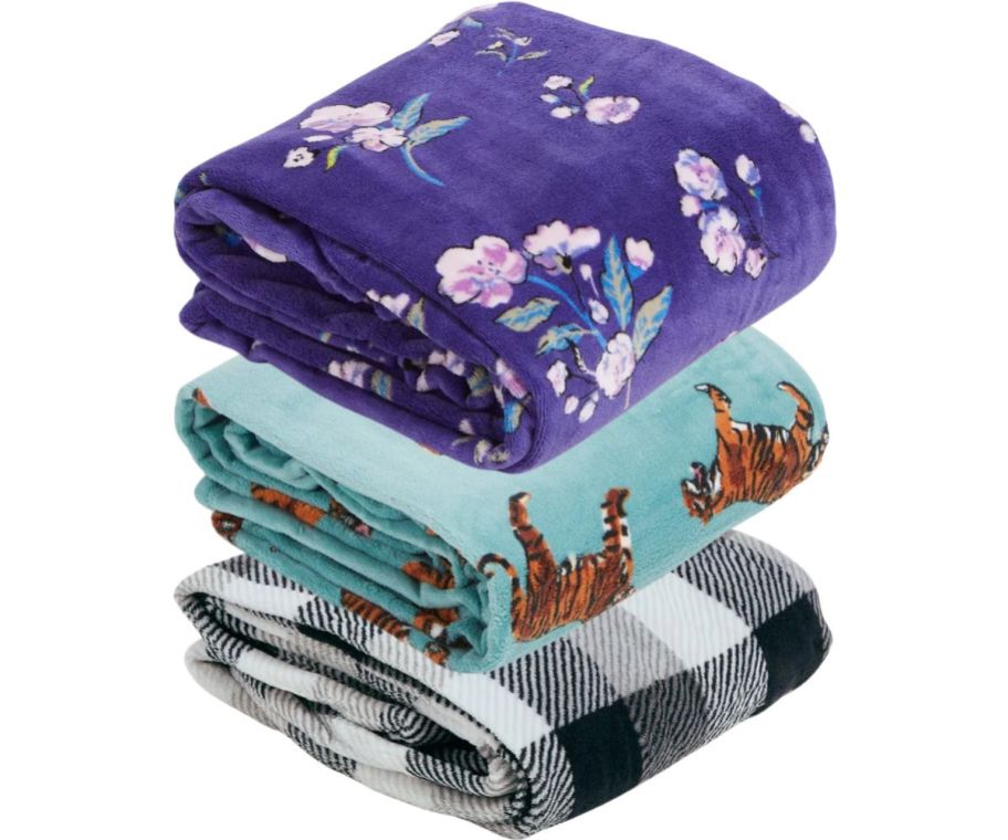 a stack of colorful throw blankets stock images