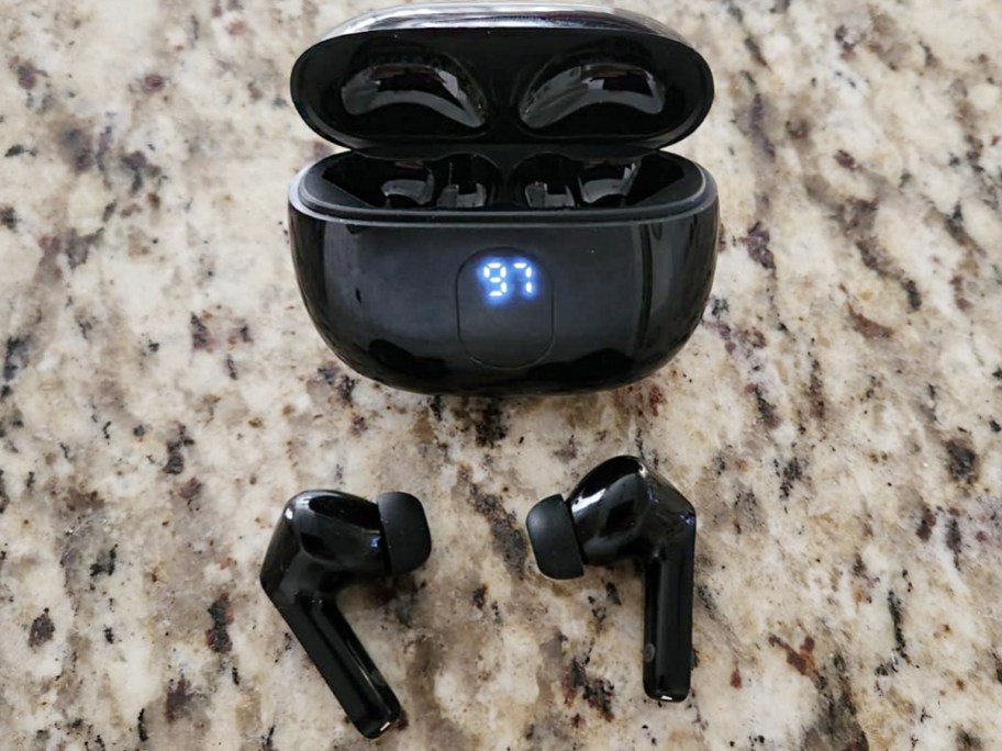 wireless ear buds and case on table