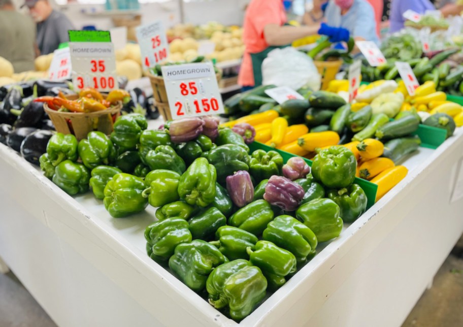 bell peppers on display at farmers market