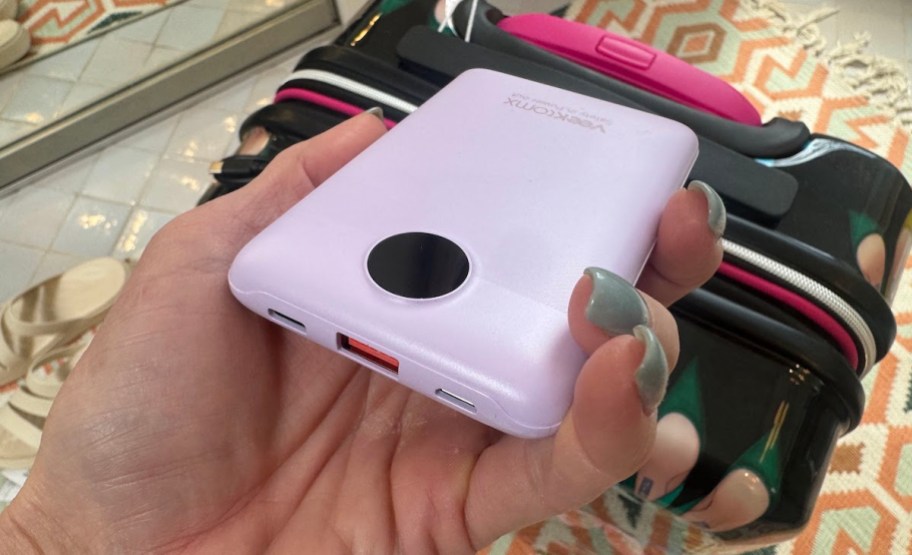 hand holding mini purple power bank