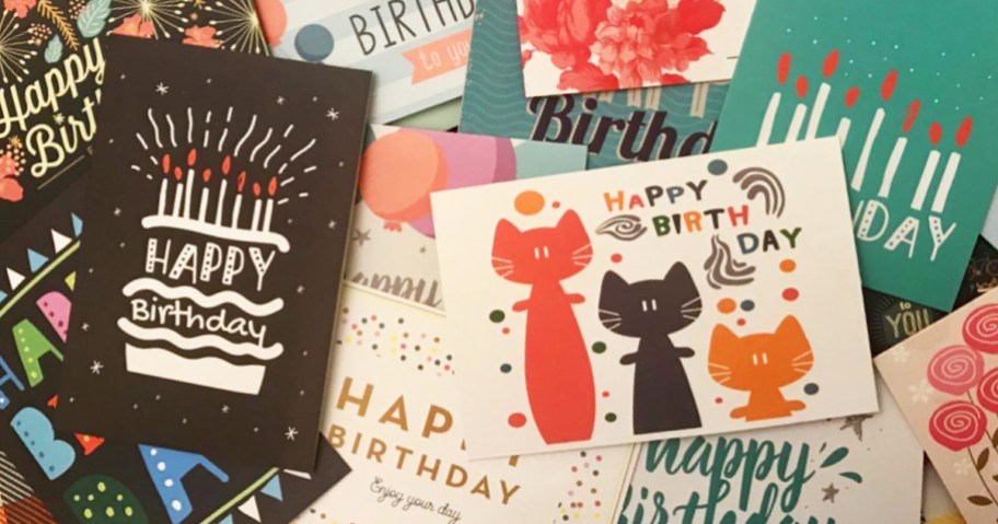 birthday cards in a pile on a table