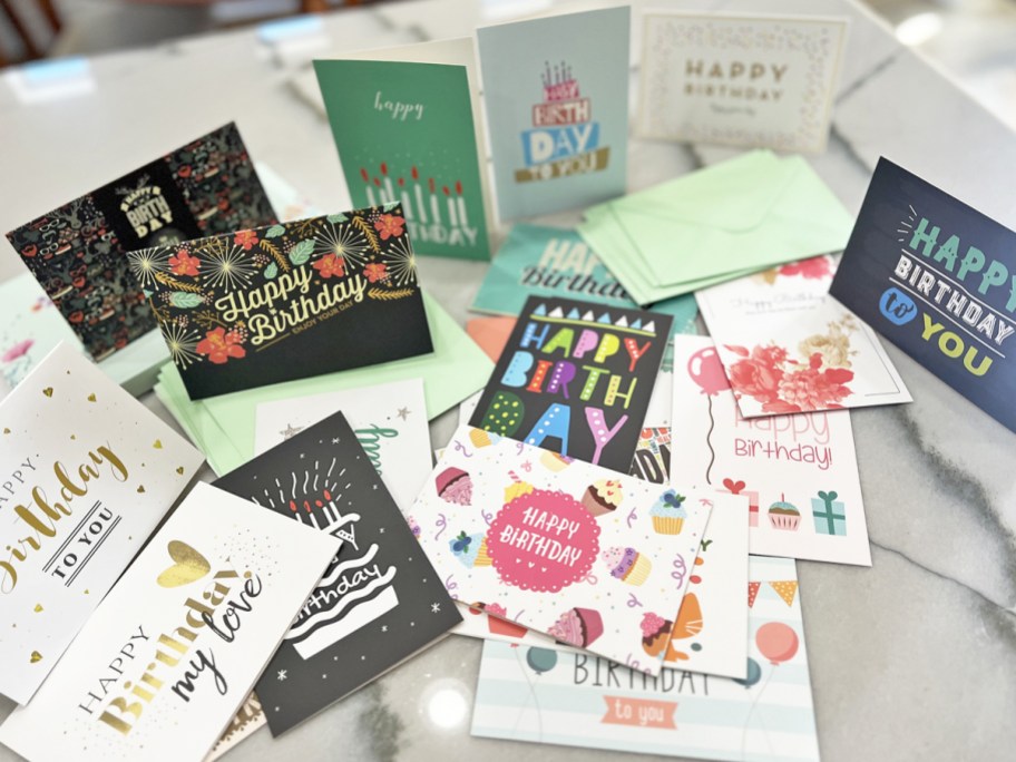 various birthday cards laid out on a table 