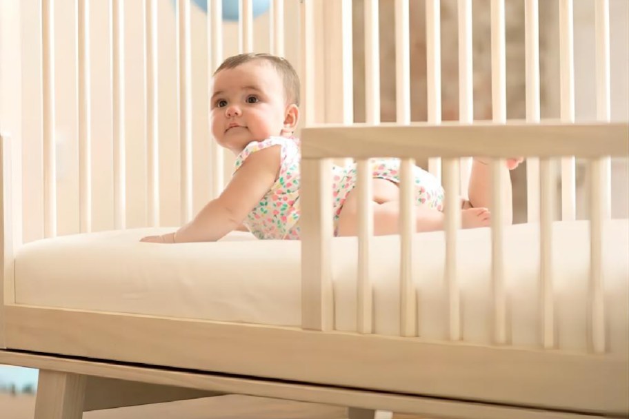 baby laying in a white baby crib