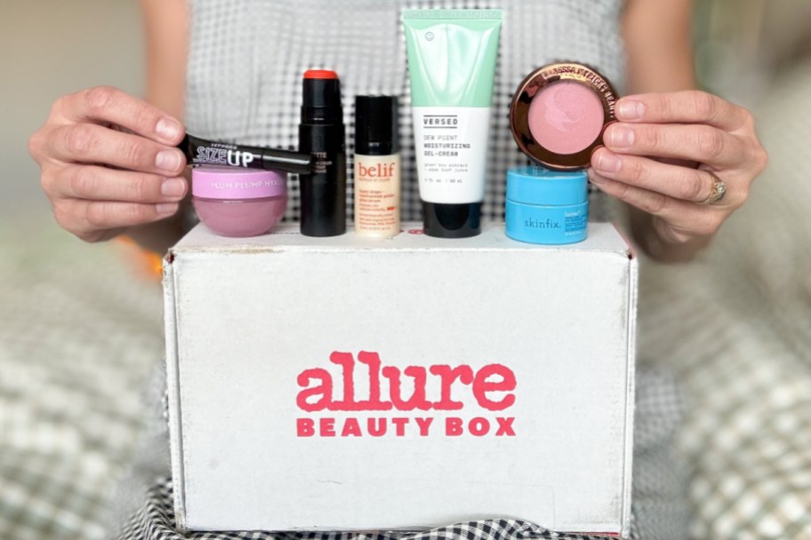 many beauty products on top of white box with red letters