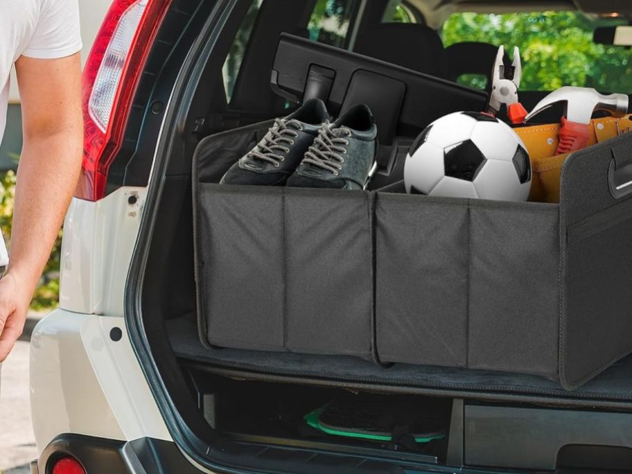 Simple Deluxe Car Trunk Organizer w/ 2 Compartments in trunk of SUV filled with sport equipment