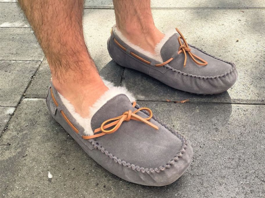 Man's feet wearing Dearfoam's Men's Fireside Victor Moccasin Slippers