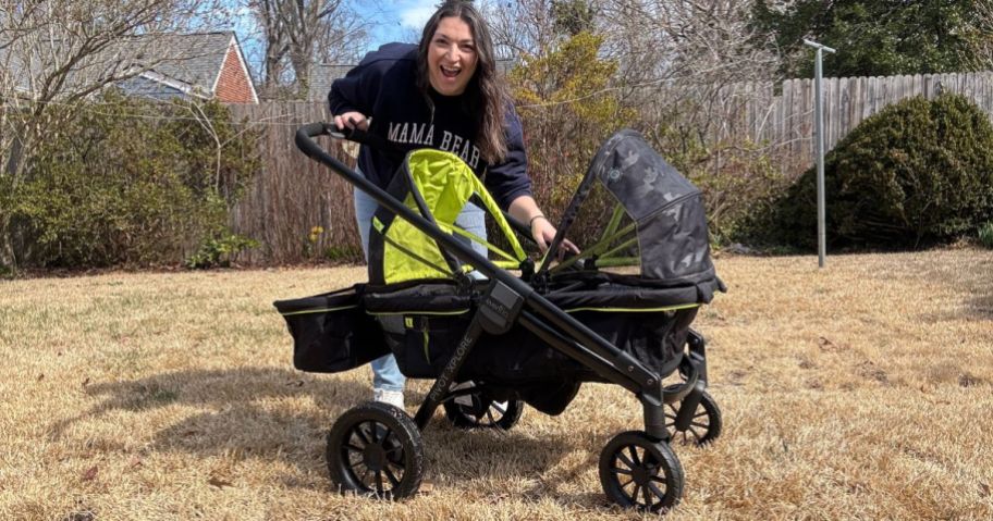 woman standing behind Evenflo stroller in yard