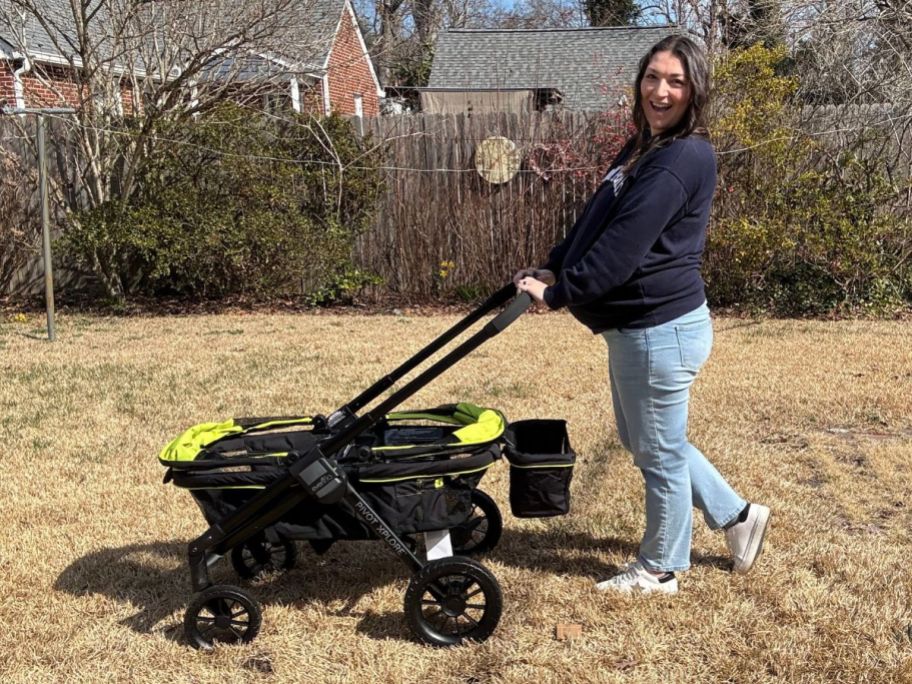 woman pushing Evenflo Stroller Wagon in yard