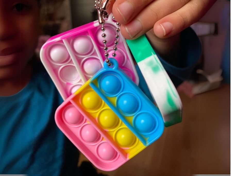 hand holding a few fidget toys