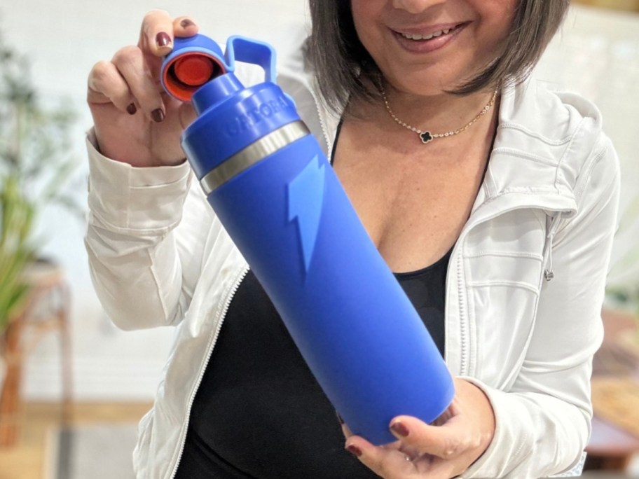 woman holding a blue stainless steel insulated Gatorade water bottle