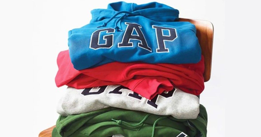 pile of GAP sweatshirts on a chair