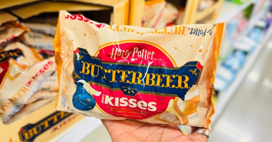 hand holding a bag of Hershey's Harry Potter Butterbeer Kisses candy