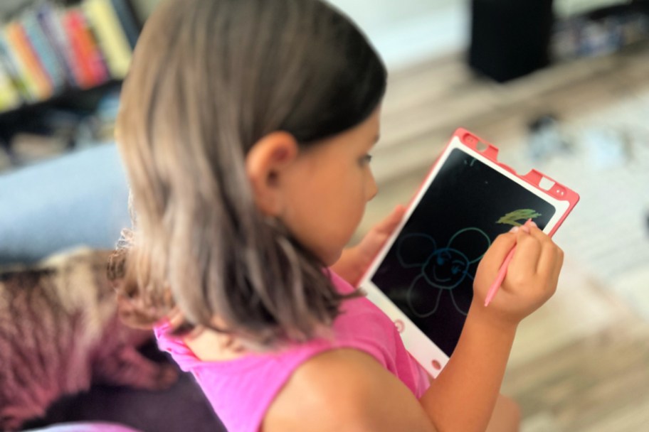 girl writing on a magic doodle board