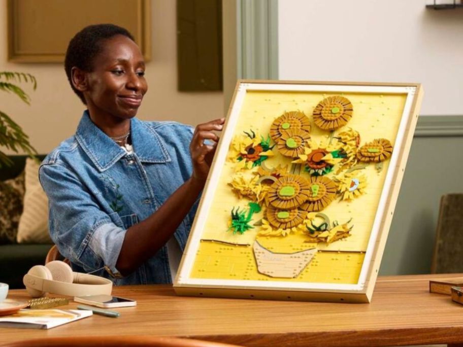 woman holding LEGO Vincent Van Gogh - Sunflowers