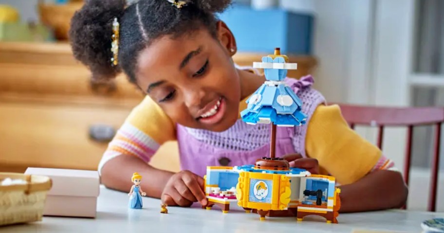 girl playing with LEGO Disney Cinderella's Dress set