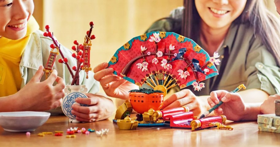 mom and kids building the LEGO Spring Festival Good Fortune set