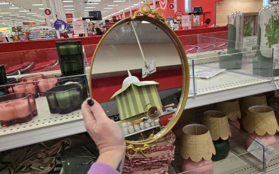 a womans hand holding a mirrored tray