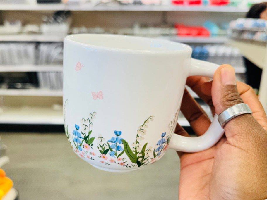 Floral mug in womans hand