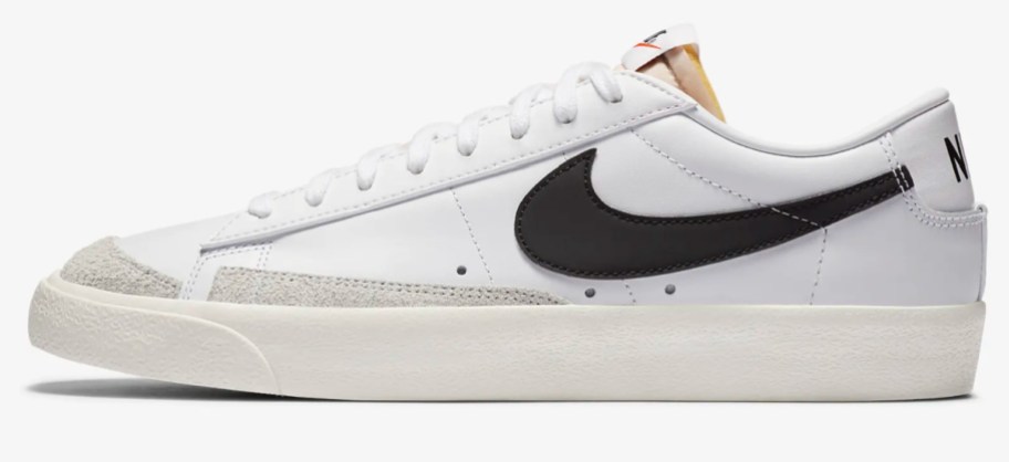 white low top shoes with black swoosh