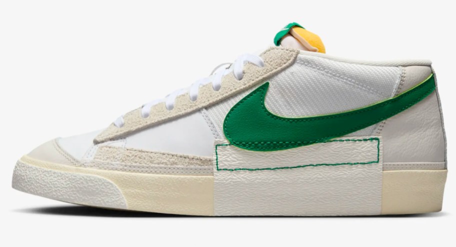 white low top sneakers with green swoosh sign