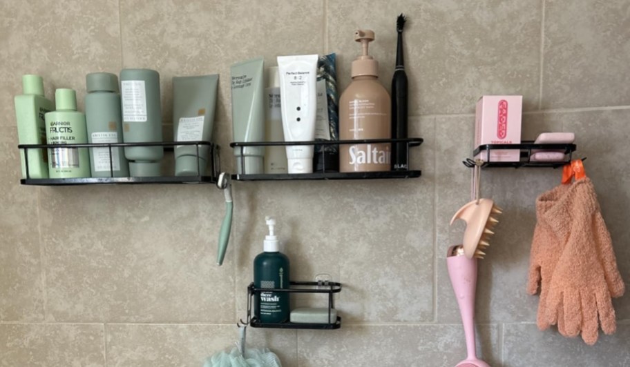 shower caddy shelves hanging on shower wall with toiletries 