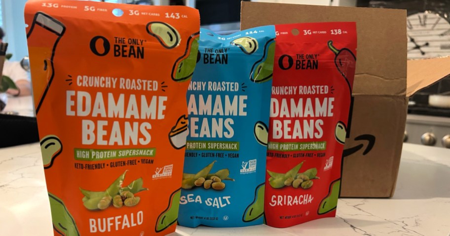 3 bags of Only Bean edamame snacks on kitchen countertop