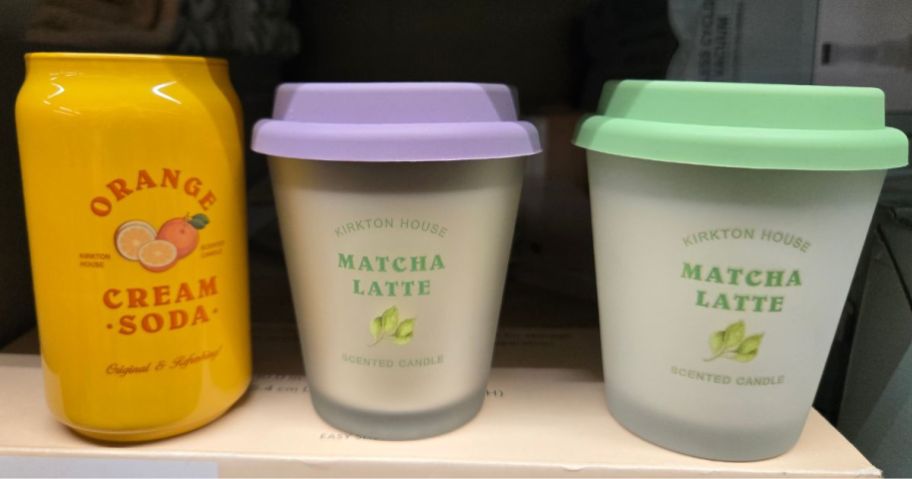 three Aldi Kirkton Scented Candles one in a can and two in a reusable latte cup