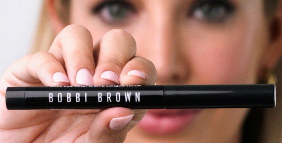 woman holding bobbi brown eyeliner