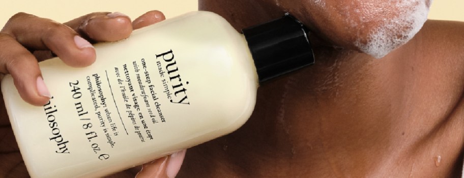 woman holding Philosophy Purity Made Simple One-Step Facial Cleanser