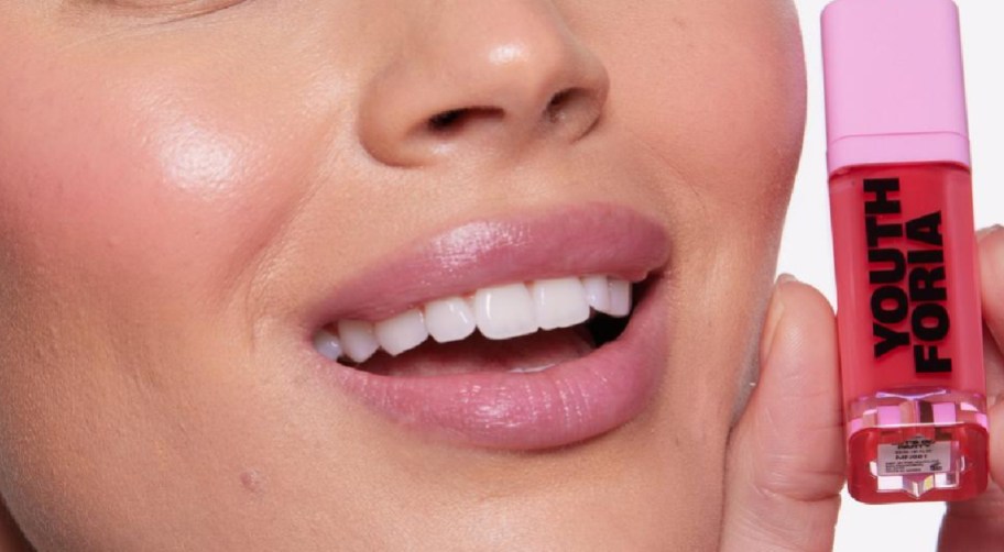 woman holding color changing blush in hand