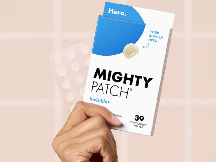 woman holding a box of Mighty Patch Invisible+ patches