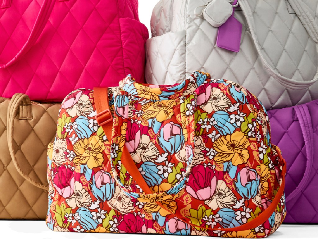 Different colored Vera Bradley weekender bag stacked on top of each other